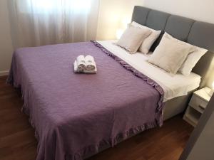 a bed with two pairs of shoes on it at Lavanda 2 in Split