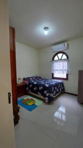 a bedroom with a bed and a window at Hostel pé da serra in Taquara