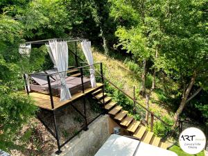 a wooden platform with a bed on a set of stairs at ARTtrend Luxury Villa in Tihany