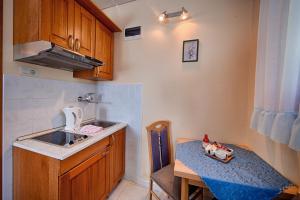 a small kitchen with a table and a sink and a counter at Nautic Studio A4 in Vis