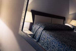 Posteľ alebo postele v izbe v ubytovaní Palazzo Ducale Suites