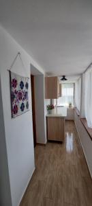 an empty living room with a kitchen and a dining room at La numărul 100, Nămăești in Nămăeşti