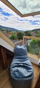 a bed in a room with a large window at Apartments Nähe Red Bull Ring in Proleb