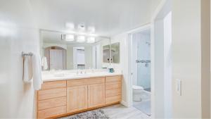 a bathroom with a sink and a toilet and a mirror at Excellent location,Relax in the heart of the City!! by Kivoya in Phoenix