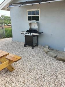 a barbecue grill sitting outside of a building at Villa Raven`s Paradise (Gris) in Willemstad