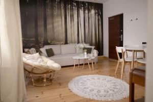 a living room with a couch and a table at Apartamenty Zwierzyniec in Zwierzyniec