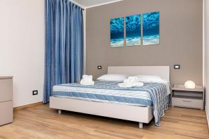 a bedroom with a bed with blue curtains at Casa marina in Genoa