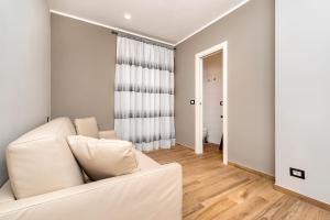 a living room with a white couch and a window at Casa marina in Genoa