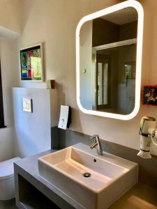 a bathroom with a sink and a mirror at casa prima vista in Torri del Benaco