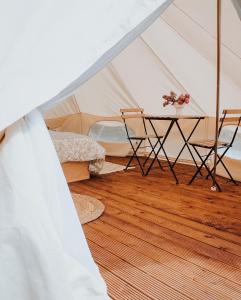 a room with a table and a tent at Rubeni in Stāķi +8 photos