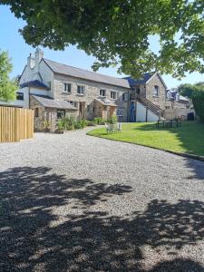 a large stone house with a large driveway at THE OLD RECTORY KIRKULLEN LOFT APARTMENT in Jacobstow 10 mins to Widemouth bay and Crackington Haven,15 mins Bude,20 mins tintagel, 27 mins Port Issac in Jacobstow