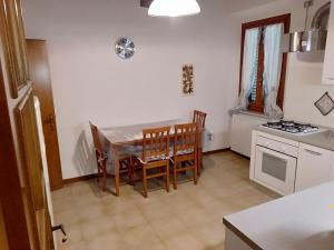a kitchen with a table and chairs and a stove at La casa di Elisa in Vinci