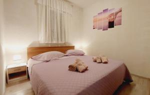 a bedroom with a bed with towels on it at Apartments Pletikosa in Brodarica