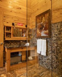 a bathroom with a shower in a log cabin at Retro Suites Hotel in Chatham