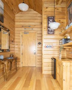 a kitchen with wooden walls and a wooden floor at Retro Suites Hotel in Chatham