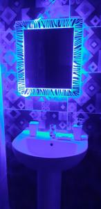 a bathroom with a white sink with a mirror at Studio apartment, Aqua View Resort, North coast in El Alamein