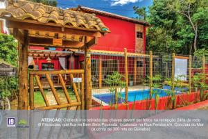 a house with a gazebo and a swimming pool at i9 Embaú Flats & Suites in Itacaré