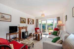 a living room with a couch and a tv at 38 Dale End in Brancaster