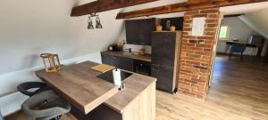 a kitchen with a wooden table and a brick wall at Apartments Nähe Red Bull Ring in Proleb