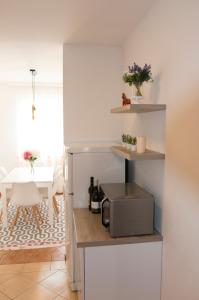 a kitchen with a counter with a microwave and a table at Memories apartment in Mostar