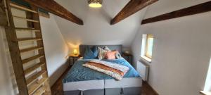 a bedroom with a blue bed and wooden ceilings at Apartments Nähe Red Bull Ring in Proleb