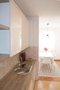 a kitchen with a sink and a table at Memories apartment in Mostar