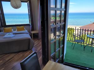 a bedroom with a bed and a view of the ocean at Dom Przy Plaży in Sarbinowo