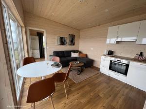 a living room with a couch and a table at Eyri Seaside Houses in Hvammstangi