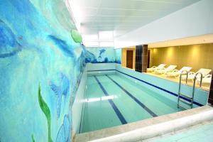 a swimming pool with a painting on the wall at The Ancient Mesopotamia Hotel in Batman