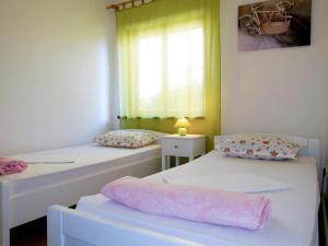 Postel nebo postele na pokoji v ubytování Apartments ORSIC