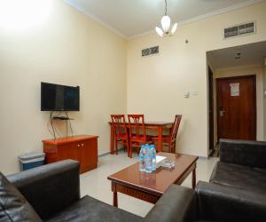 a living room with a couch and a table at Al Sharq Hotel Suites - BAITHANS in Sharjah