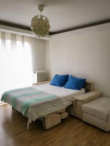 ニースにあるMagnifique appartement vacances proche de la merのベッドルーム1室(青い枕とシャンデリア付きのベッド1台付)