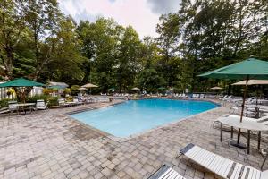 a large swimming pool with chairs and umbrellas at Buckberry Creek Unit 1 in Gatlinburg