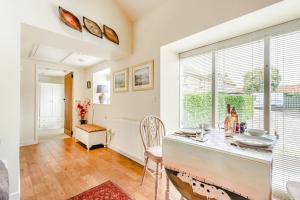a dining room with a table and a large window at Cow Byre Cottage in Snainton +17 photos