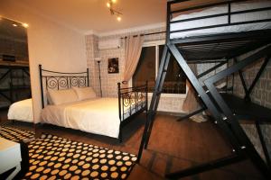a bedroom with a large bed and a staircase at Elegant home in Madinaty compound in Cairo