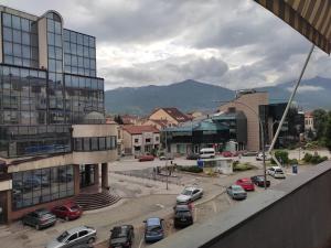a city with cars parked in a parking lot at Magic apartment in Bitola