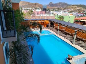 a swimming pool on the side of a building at Hotel Hacienda Morales. in Guanajuato