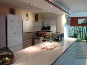 a kitchen with white appliances and a counter top at villa NYL in Schœlcher
