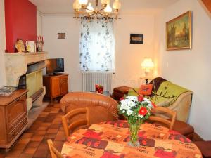 a living room with a table with a vase of flowers on it at Gîte Montlouis-sur-Loire, 3 pièces, 4 personnes - FR-1-381-436 in Montlouis-sur-Loire