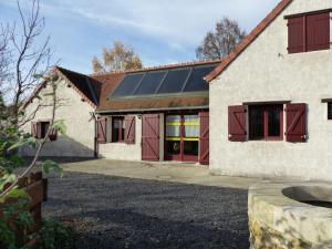 a house with solar panels on the side of it at Gîte Dompierre-sur-Besbre, 4 pièces, 6 personnes - FR-1-489-51 in Dompierre-sur-Besbre