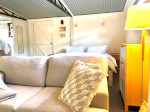 a living room with a couch and a bed at Capri Retreat - For Couples in Saint Andrews Beach