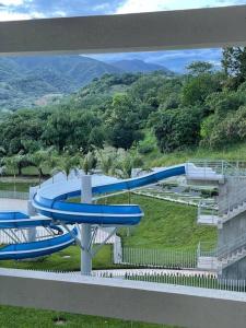 a blue water slide in a park at Hermoso apartamento en SANTA FE DE ANTIOQUIA in Medellín