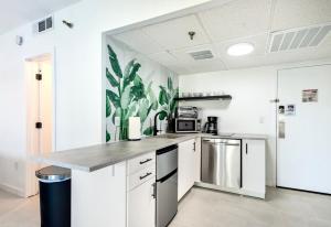 a kitchen with white cabinets and stainless steel appliances at Studio near Universal Studios with great view in Orlando