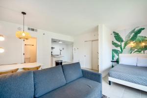 a living room with a blue couch and a table at Studio near Universal Studios with great view in Orlando +17 photos