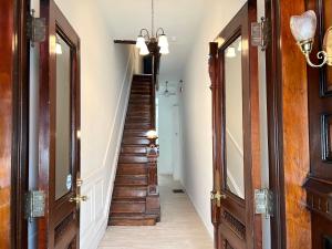a hallway with wooden doors and a stairway at Alina & Fanny - Philadelphia S Broad St in Philadelphia