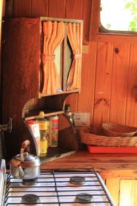 a stove top with a pot on top of it at La Casa del Viajero Hostel in El Bolsón