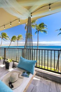 a hammock in a room with a view of the ocean at Spectacular luxury , modern oceanfront condo Maalaea-Kihei ,Maui in Wailuku