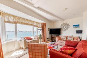 a living room with a view of the ocean at Battery House in Portsmouth