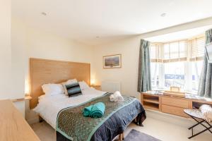 a bedroom with a bed and a window at Battery House in Portsmouth