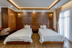 Postel nebo postele na pokoji v ubytování Hotel Trí Lê